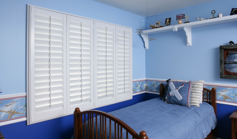 Blue kids bedroom with white plantation shutters in New Brunswick 